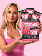 Woman holding a box filled with the mini energy and focus watermelon gummies.