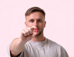 Man holding a red lightning bolt-shaped PowerCUBE Watermelon caffeine gummy towards the camera.