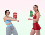 Two girls doing a little dance with powercube creatine and electrolyte gummies, girl on right in red activewear with sour watermelon and girl on left in blue activewear and grey tracksuits with sour cola.